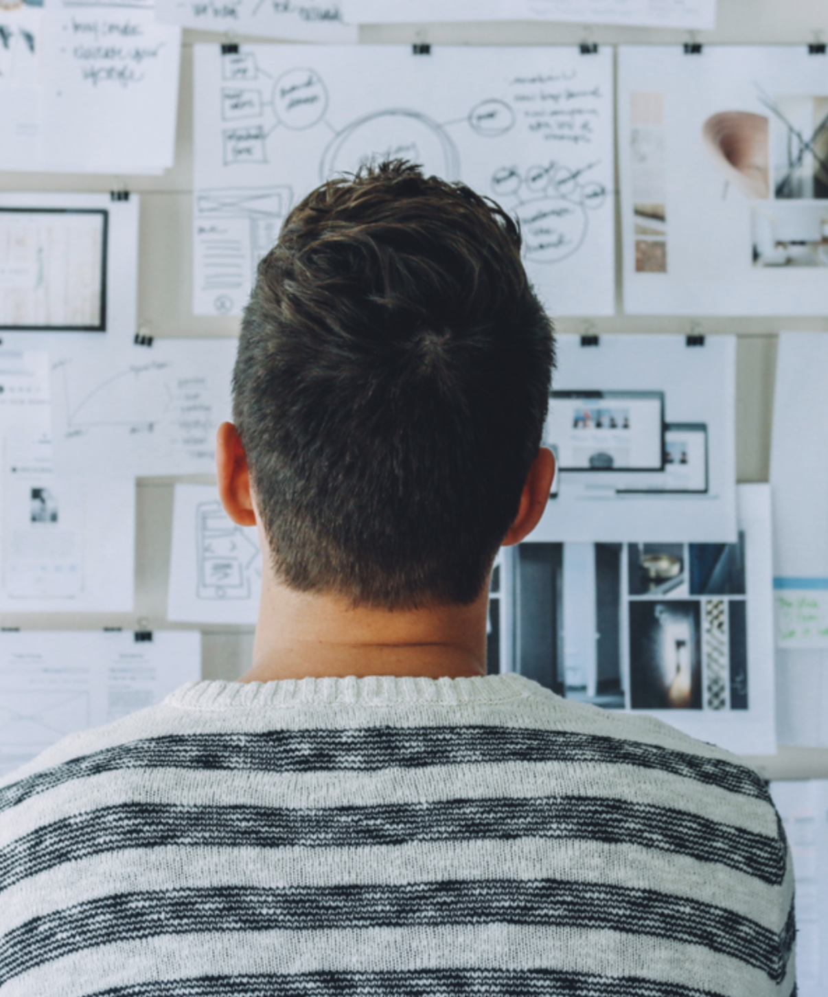 Person looking at notes on wall.